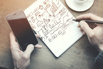 Canvas Print - man working -hand pen and phone, coffee on table