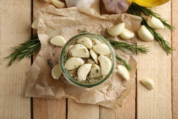 Garlic with spices on wooden table