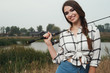 © dmitry_zubarev - country lady standing against pond on ranch with fish-rod