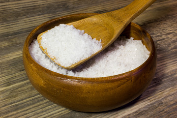 Large sea salt on wooden background