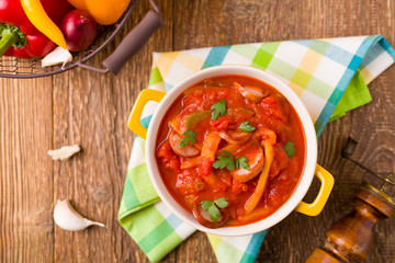 Delicious letcho with fresh vegetables, served in a yellow pot w