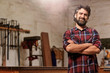 Small carpentry business owner smiling with arms crossed