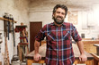 © mavoimages - Smiling bearded craftsman in his woodwork studio