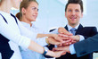 © lenets_tan - Business people with their hands together in a circle