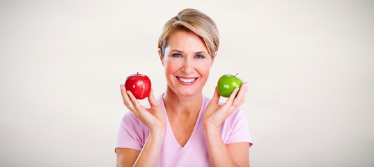 Wall Mural - Mature smiling woman with apple.