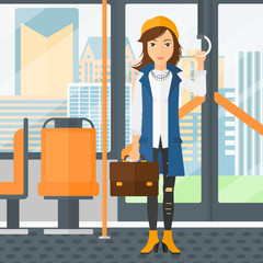 Canvas Print - Woman standing inside public transport.