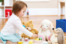 Toddler Girl Playing With Her Stuffed Animals
