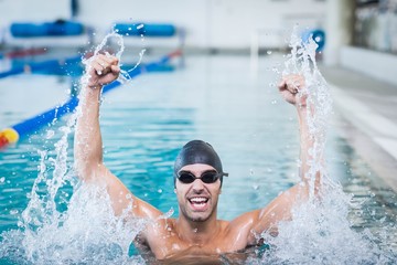 Wall Mural - Handsome man triumphing with raised arms