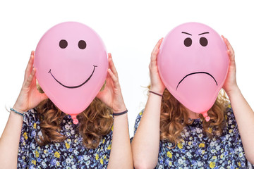 Two girls holding pink balloons with facial expressions for head