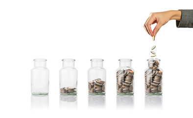 Glass jars with coins, savings concept