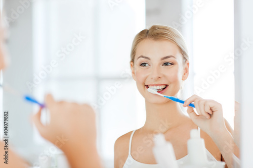 Cuadros en Lienzo woman with toothbrush cleaning teeth at bathroom