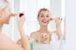 © Syda Productions - woman with makeup brush and powder at bathroom