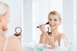 © Syda Productions - woman with makeup brush and blush at bathroom