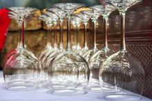 Empty Wine Glasses Upside Down In Rows On A White Tablecloth Outside