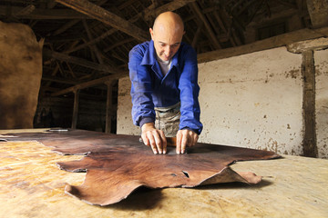 traditional  tanner  with old tools and machinery  in the antique tannery