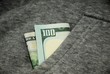 $100 bill sticking out of a pocket