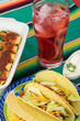 Mexican fiesta table.Tacos, enchiladas and glass of sangria.