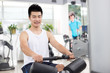 © zhu difeng - young man working out in modern gym