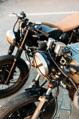 Two black and silver vintage custom motorcycles cafe racers