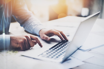 Photo businessman working with generic design notebook. Typing message, hands keyboard. Blurred background, bokeh effect