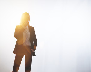 Wall Mural - Businesswoman talking by smartphone. Empty background, visual effects, isolated