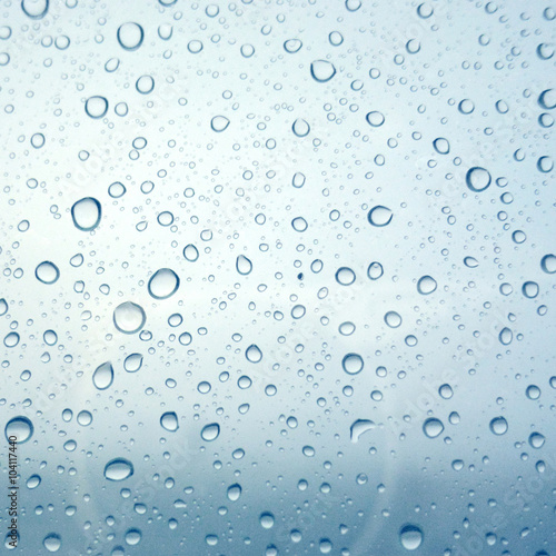 Naklejka na kafelki Close-up of water drops on glass surface as background