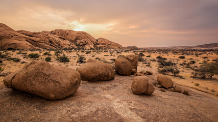 typical round stones in the namibian savanna at sunset