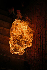 Fire artist performing fire breathing