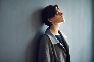 Portrait of tired beautiful woman on dark background