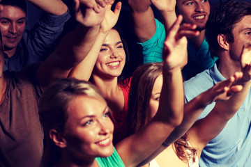 smiling friends at concert in club