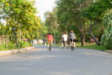 Fototapeta  - three people on bicycle blur background