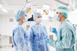 © Syda Productions - group of surgeons in operating room at hospital