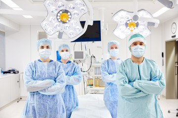 Wall Mural - group of surgeons in operating room at hospital