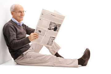 Sticker - cheerful senior reading a newspaper