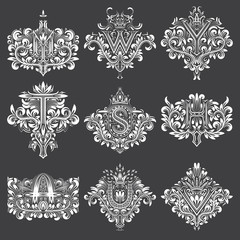 Wall Mural - Set of ornamental monogram in coats of arms form. White floral decorations on black. Isolated tattoos in vintage baroque style.