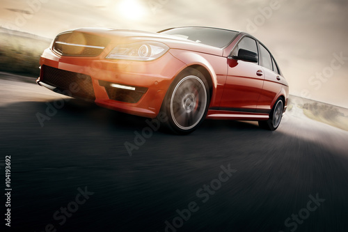 Zdjęcie XXL Czerwony samochód sportowy Szybka prędkość jazdy na asfaltowej drodze