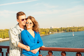 Sticker - Happy cheerful couple in love embracing each other on the bridge