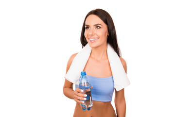 Poster - Attractive sportswoman with towel holding a bottle with fresh wa