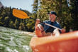 © Jacob Lund - Mature man paddling a kayak
