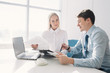 © lumenphotos - Two colleagues discussing a business project, a man and a woman