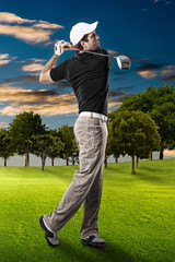 Wall Mural - Golf Player using a black uniform.