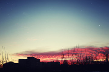 Wall Mural - red sunset sky silhouettes of buildings