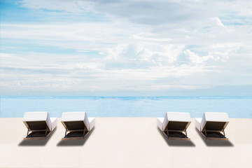 Wall Mural - The beach in summer, clear sand and blue sky with beach chairs, idyllic travel background