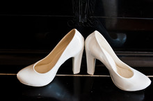 White Wedding Shoes Of Bride In Piano