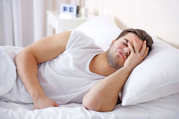 Wall Mural - Young man lying in bed at home