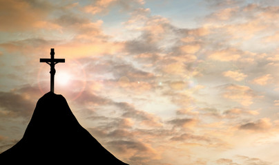 Wall Mural - Silhouette Jesus and the cross over sunset on mountain top