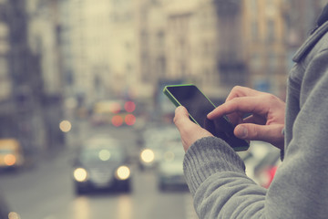 Man using cellphone outdoors.
