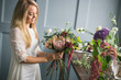 © cherry_d - Florist at work: pretty young blond woman making fashion modern bouquet of different flowers