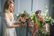 © cherry_d - Florist at work: pretty young blond woman making fashion modern bouquet of different flowers