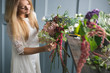 © cherry_d - Florist at work: pretty young blond woman making fashion modern bouquet of different flowers